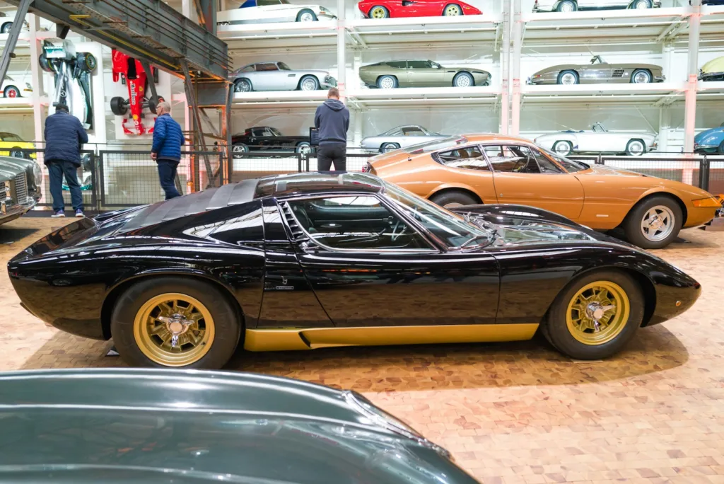 a couple of cars are parked in a garage