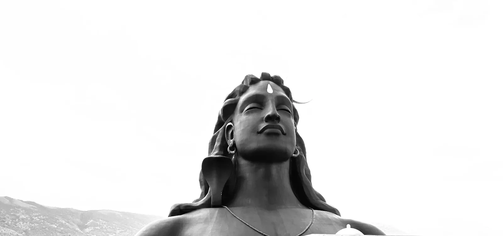 a black and white photo of a statue of a woman