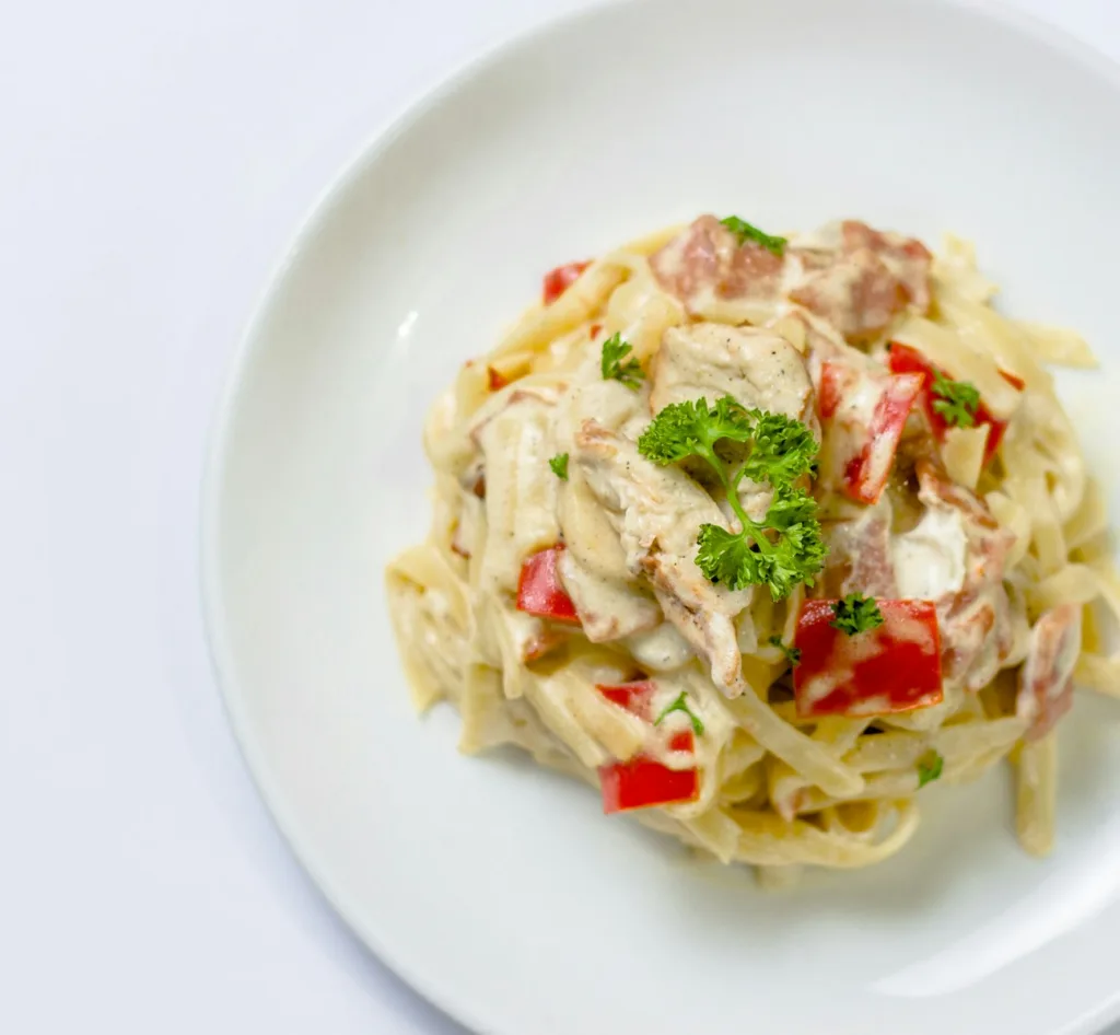 plate of white pasta with red bell pepper