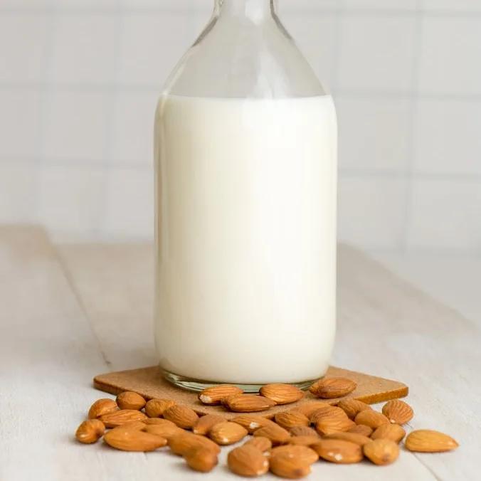 white milk in clear glass bottle